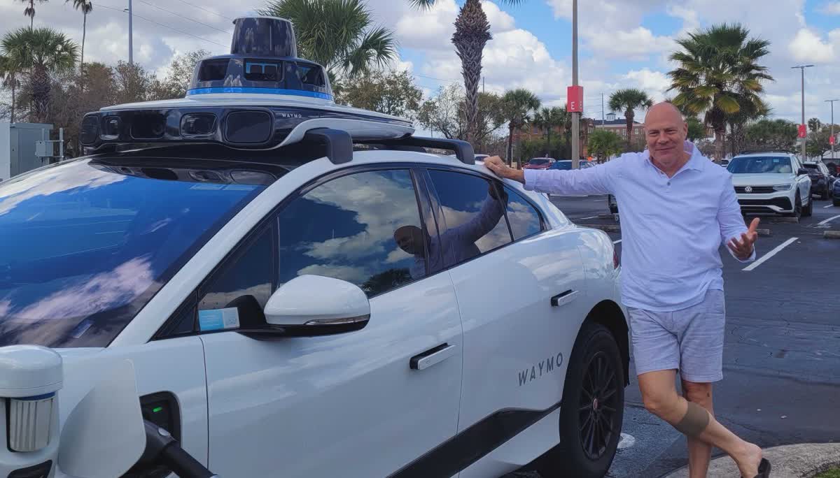 Mike Slatton next to a Waymo self-driving car in Florida